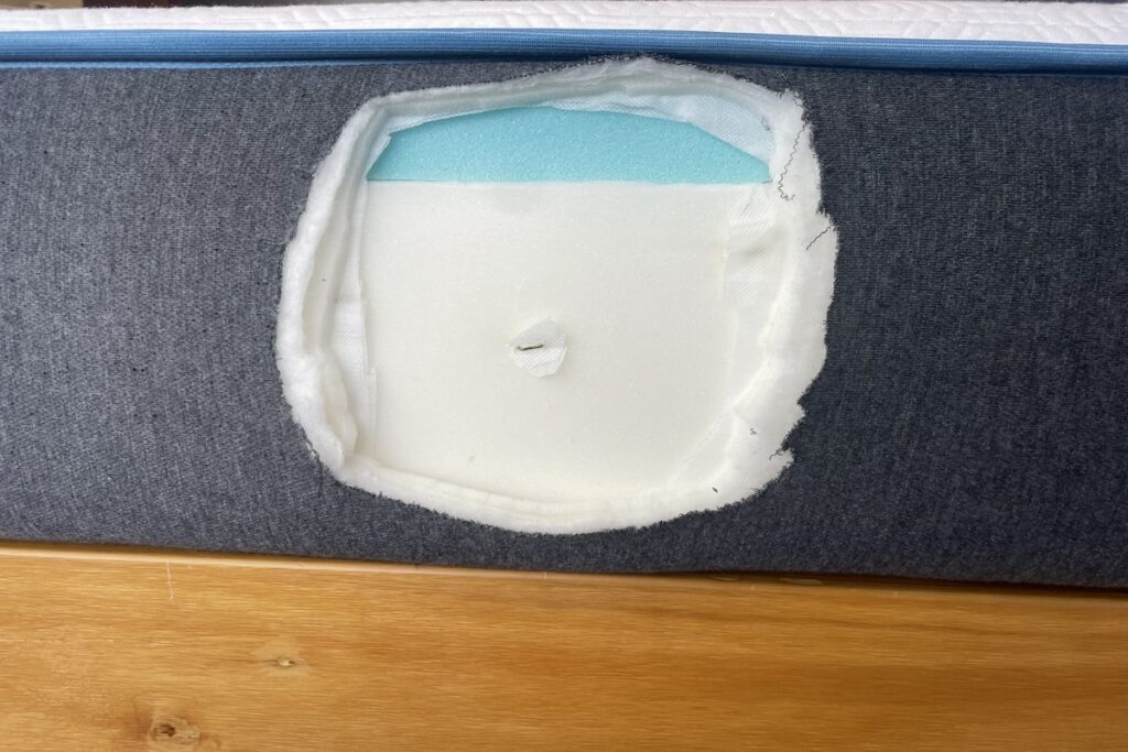 A circular opening in the side of the Bear Original mattress shows its memory foam composition.