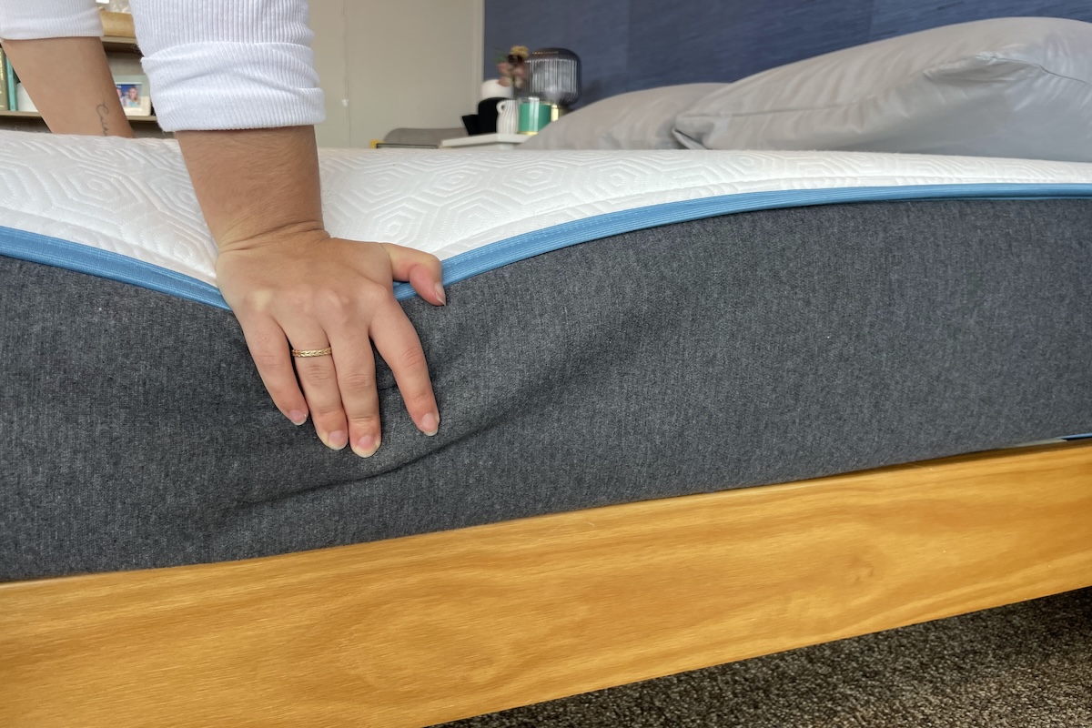 Our tester pushes down on the Bear Original to test firmness