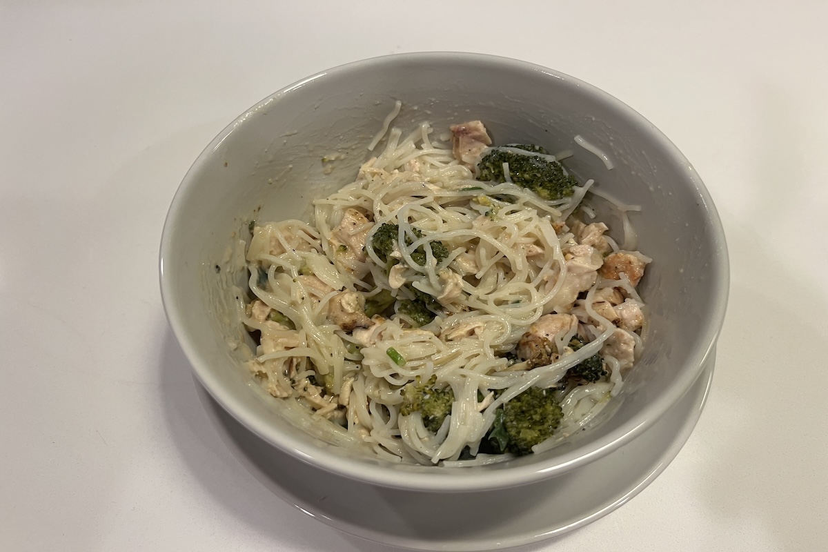 Creamy Chicken and Broccoli Alfredo meal from Fresh N Lean after being heated.
