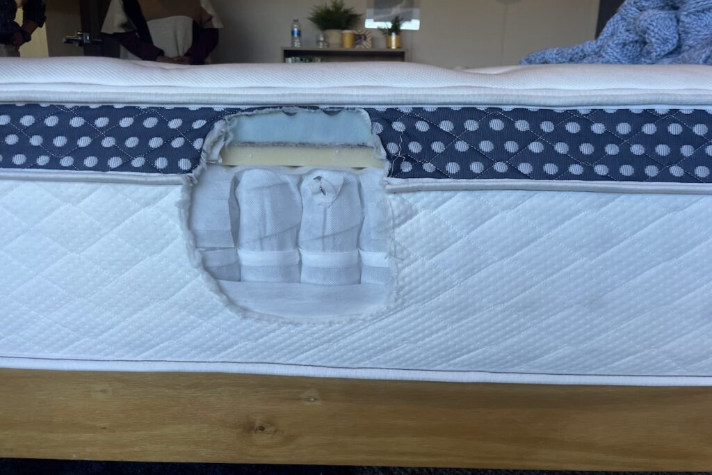A side view of The WinkBed with a cutout showing the mattress's interior composition